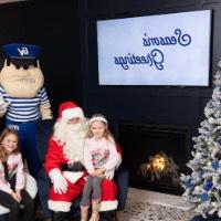 Louie the Laker and Santa with girls in pink sweaters